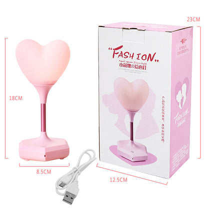 Pink heart shaped night lamp with out packaging next to it