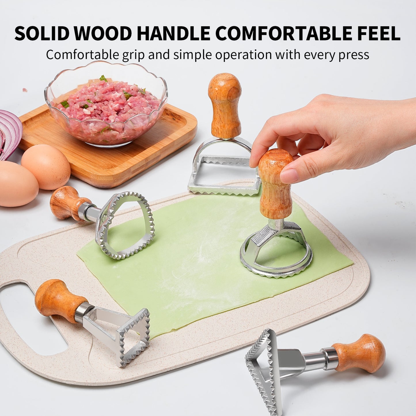 5 dumpling moulds on the table with some dough