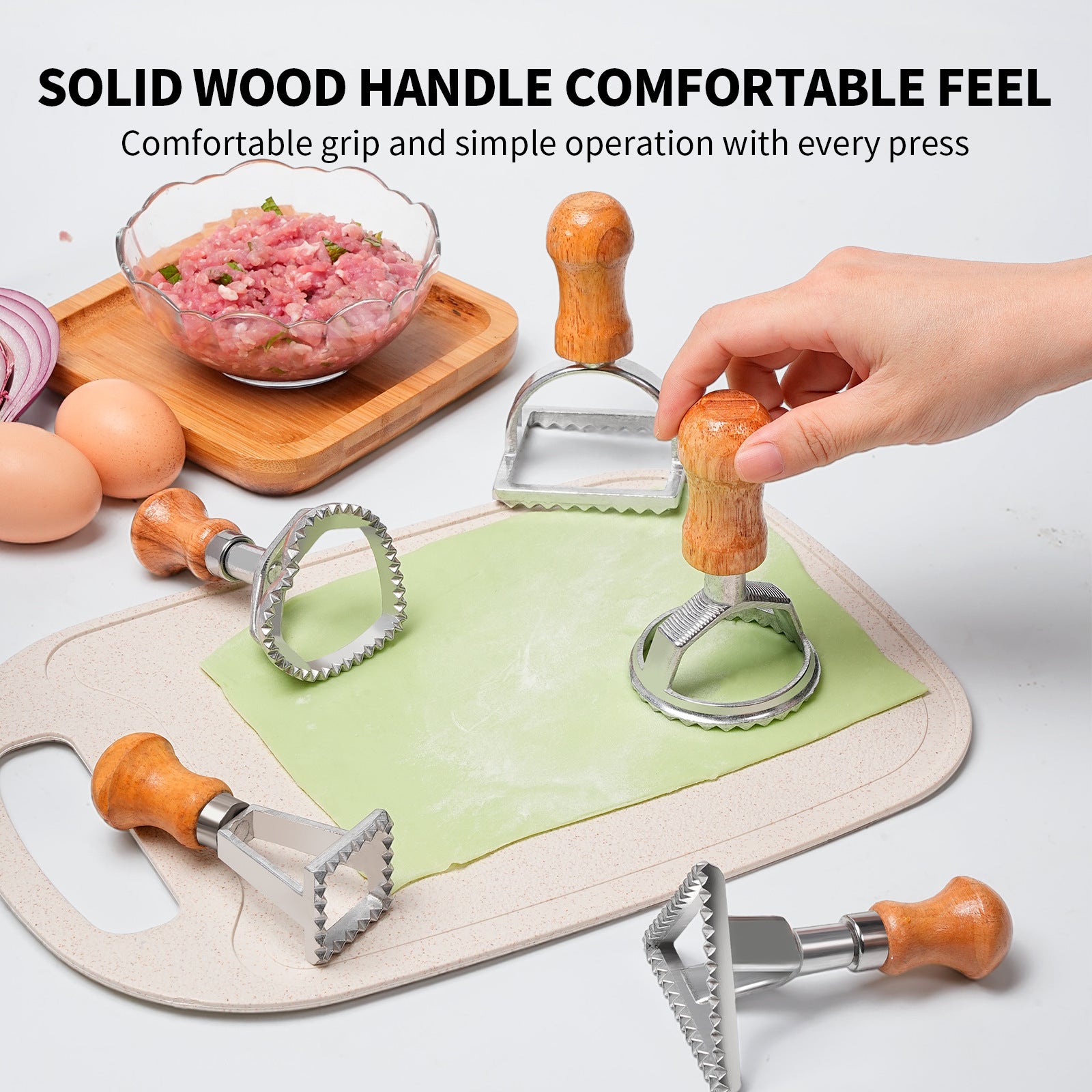 5 dumpling moulds on the table with some dough