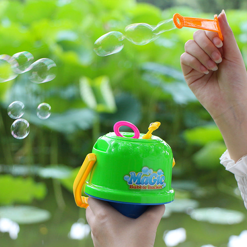A hand using Magical Bubble Toy Bucket