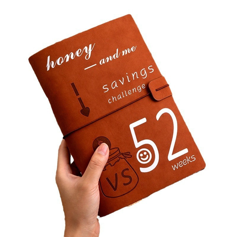A person holding brown saving planner in a white background