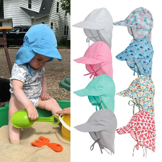 Child playing in the sand and 8 different colour bucket hats