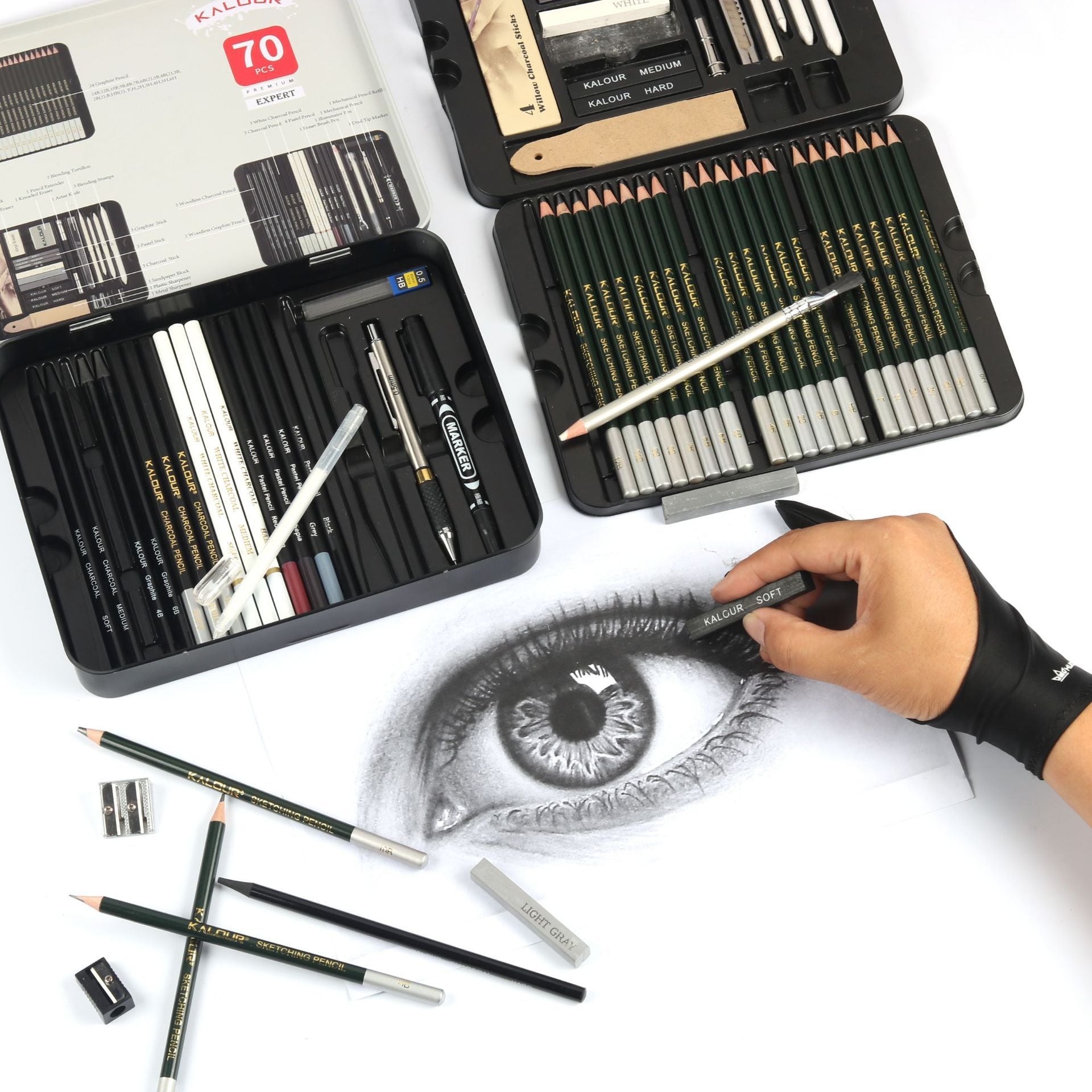 a hand drawing an eye with 70 pieces of sketch pencil set