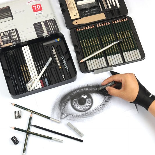 a hand drawing an eye with 70 pieces of sketch pencil set