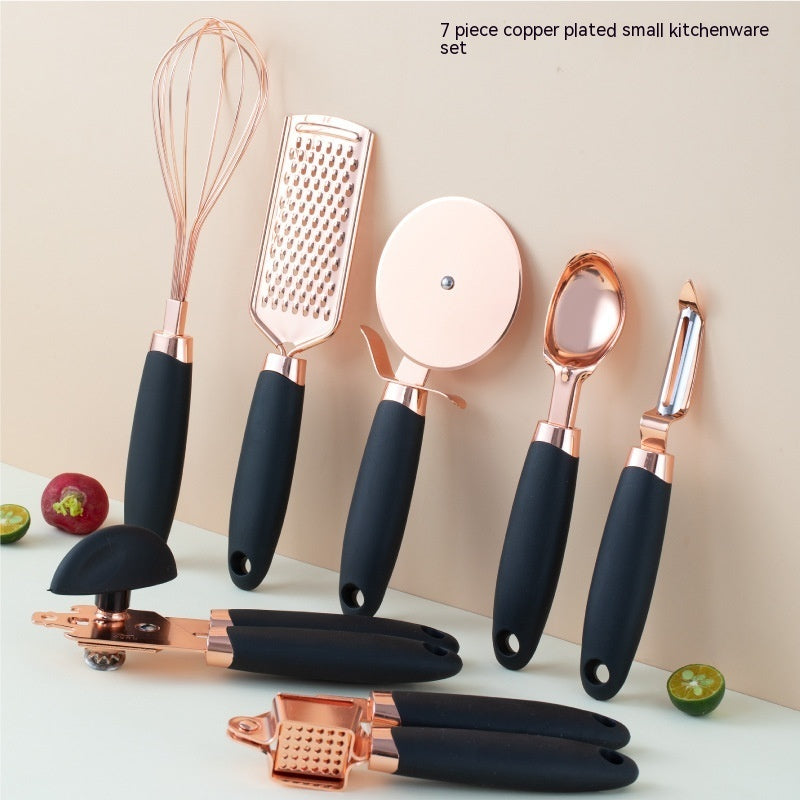 black and copper 7 pcs kitchen utensil set in a pink background