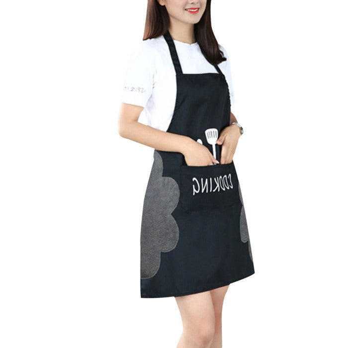 black kitchen apron with kitchen utensils in it