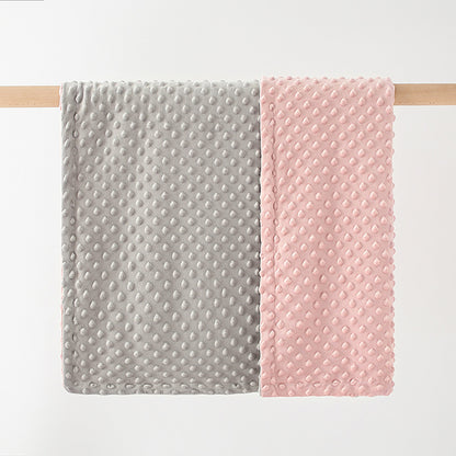 pink grey baby blanket hung up