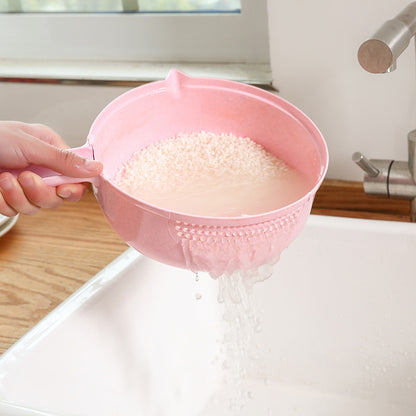 pink sieve with rice in it under tap water