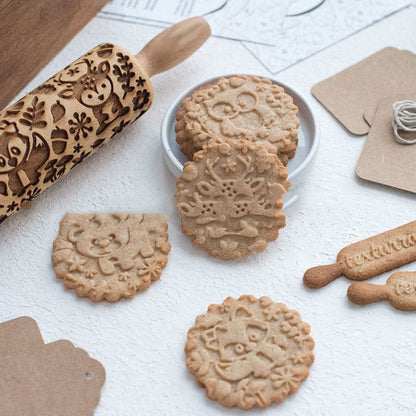rolling pin with some cookies on the table