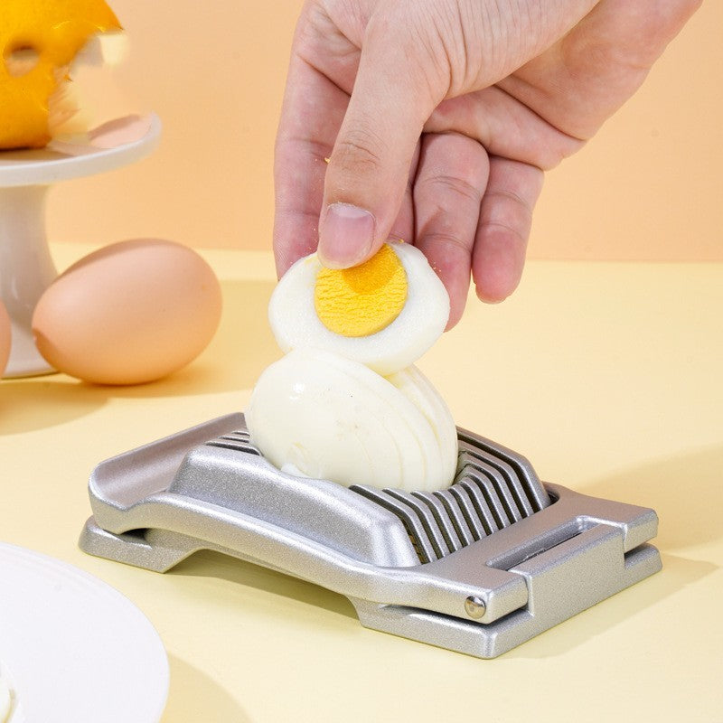 silver egg cutter in action with an egg