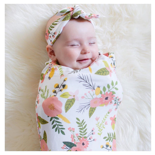 smiling baby wrapped in Baby blanket