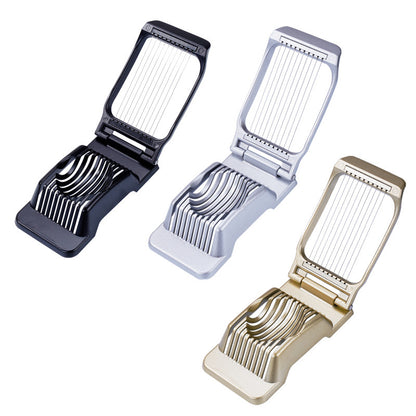 three egg cutters: black grey and gold