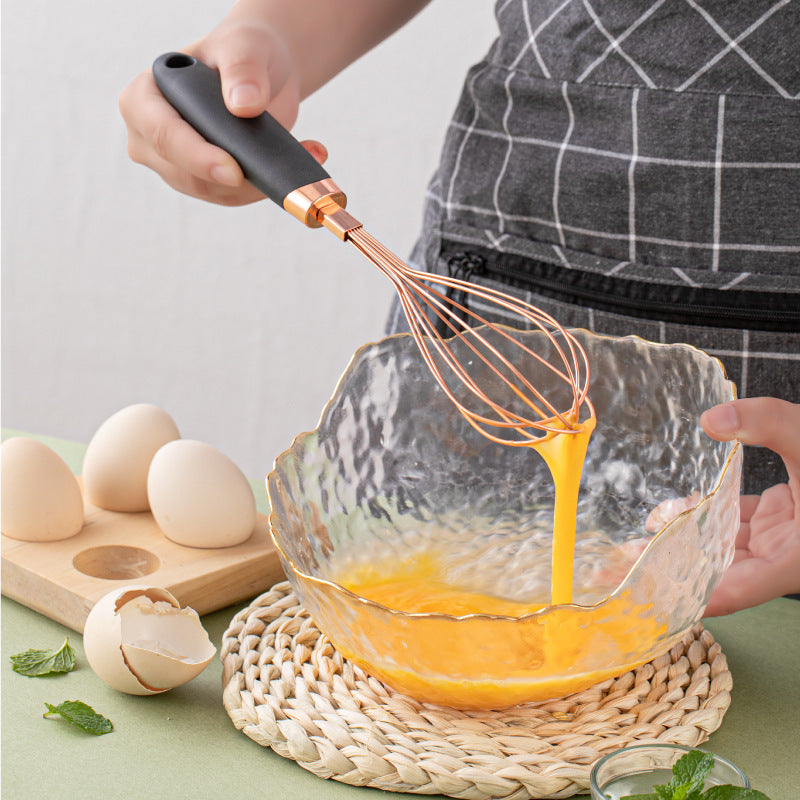 woman whisking an egg